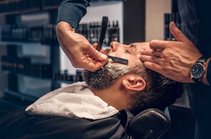 barber-shaving-bearded-male-with-a-sharp-razor-2021-08-28-17-38-11-utc