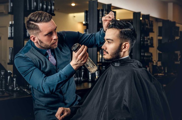 hairdresser-doing-haircut-to-a-bearded-man-in-a-ba-2021-08-28-17-38-11-utc
