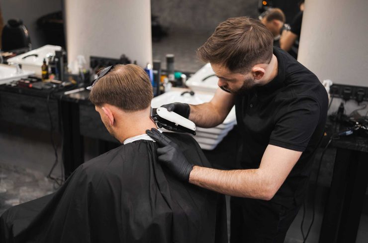 male-hairdresser-making-a-haircut-for-a-young-man-2022-02-17-20-02-40-utc