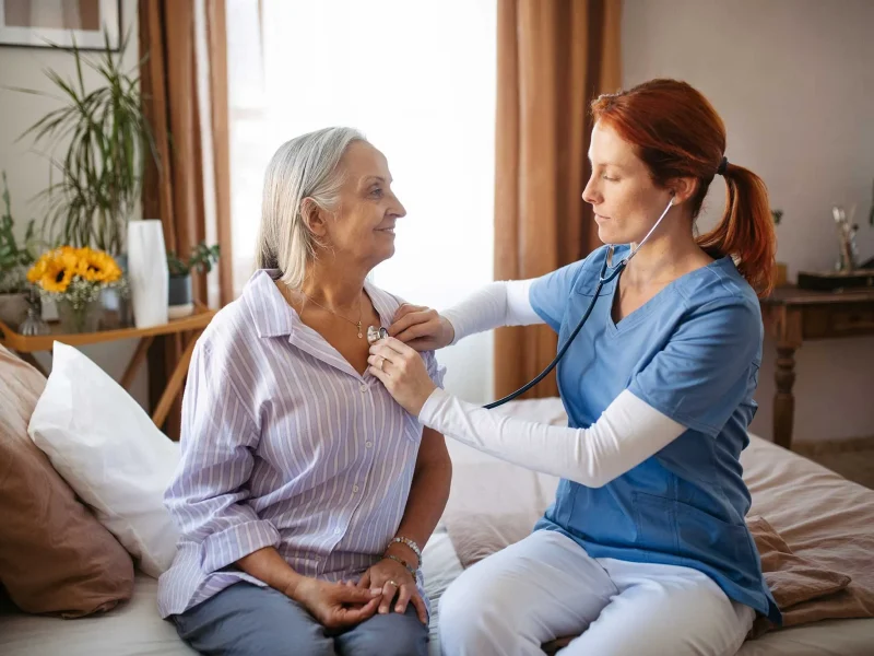 nurse-examining-senior-patient-with-stethoscope-at-2023-11-27-04-49-31-utc