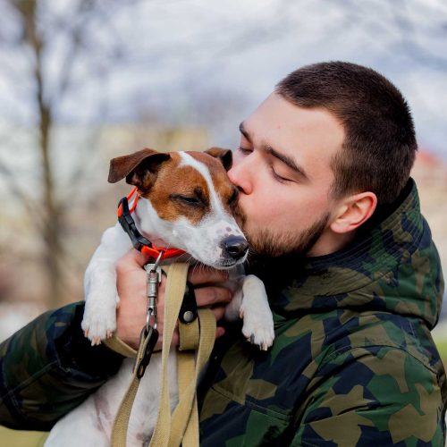 young-man-with-his-dog-jack-russell-terrier-2022-01-12-05-09-31-utc.jpg