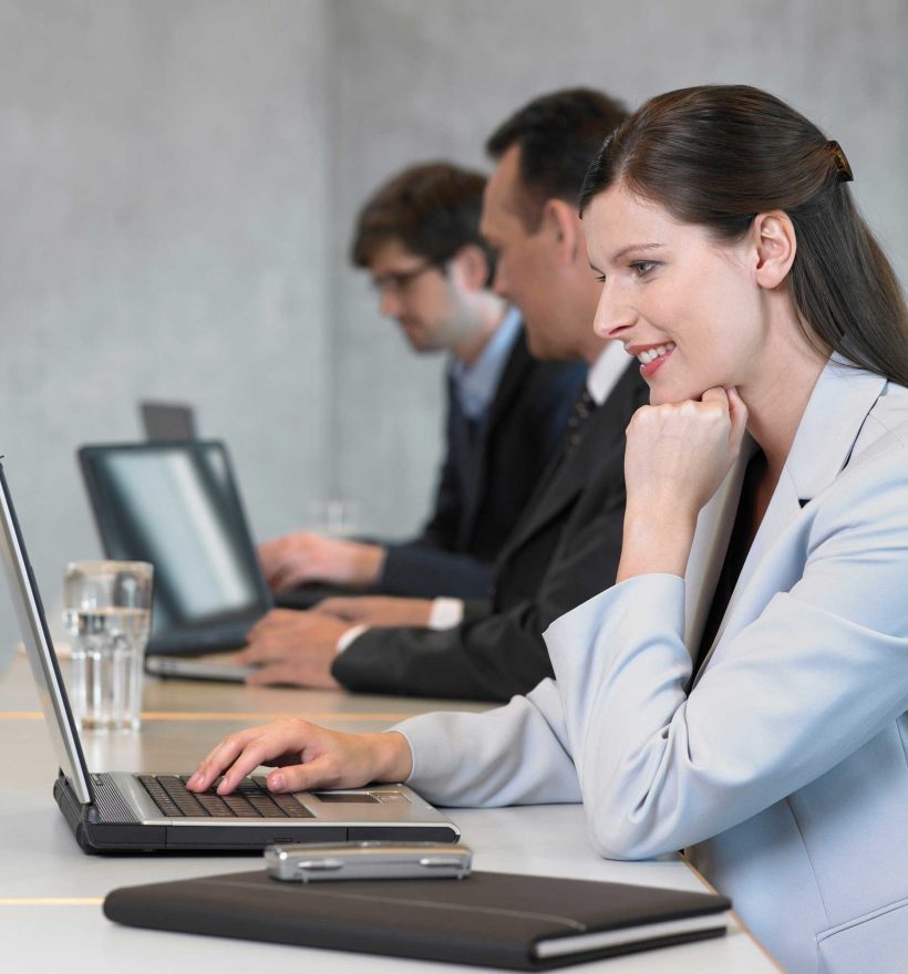 businesswoman-using-laptop-smiling-2022-03-08-00-21-51-utc