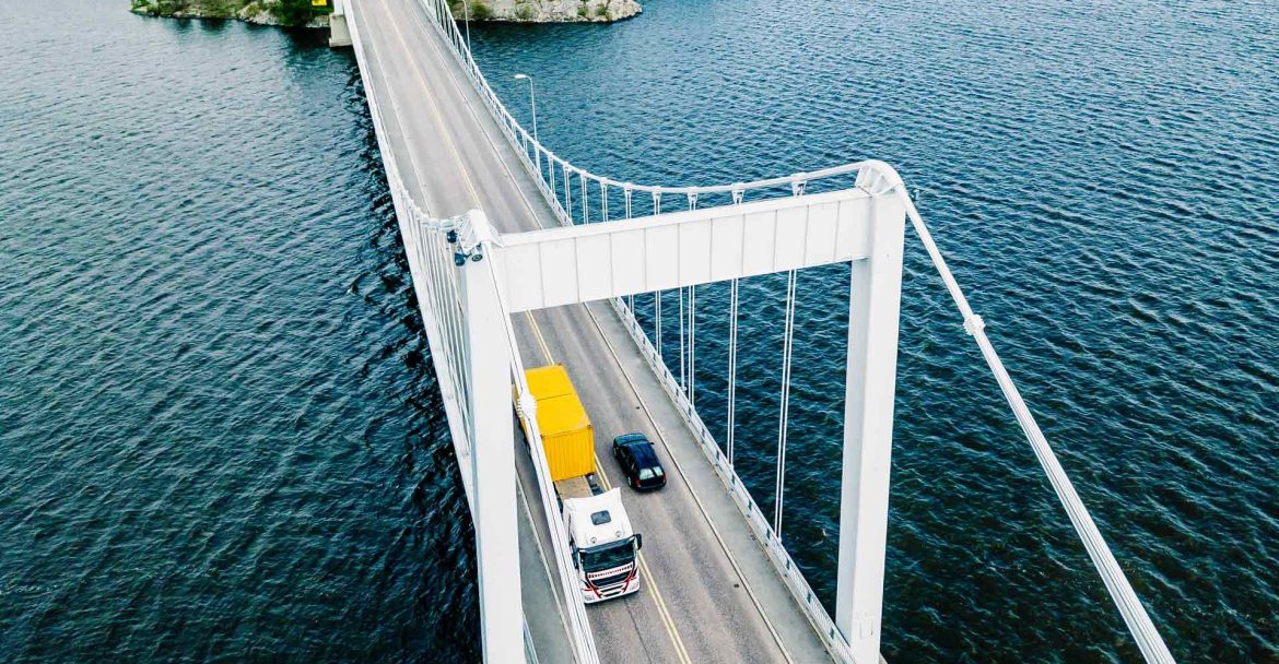 aerial-view-of-white-suspension-bridge-with-car-cr-93U58A5.jpg