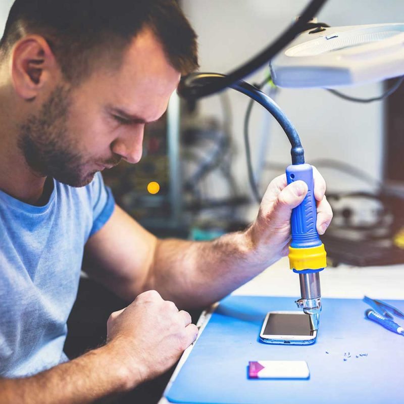 man-repairing-smartphone-at-workplace-2022-03-04-05-57-51-utc.jpg