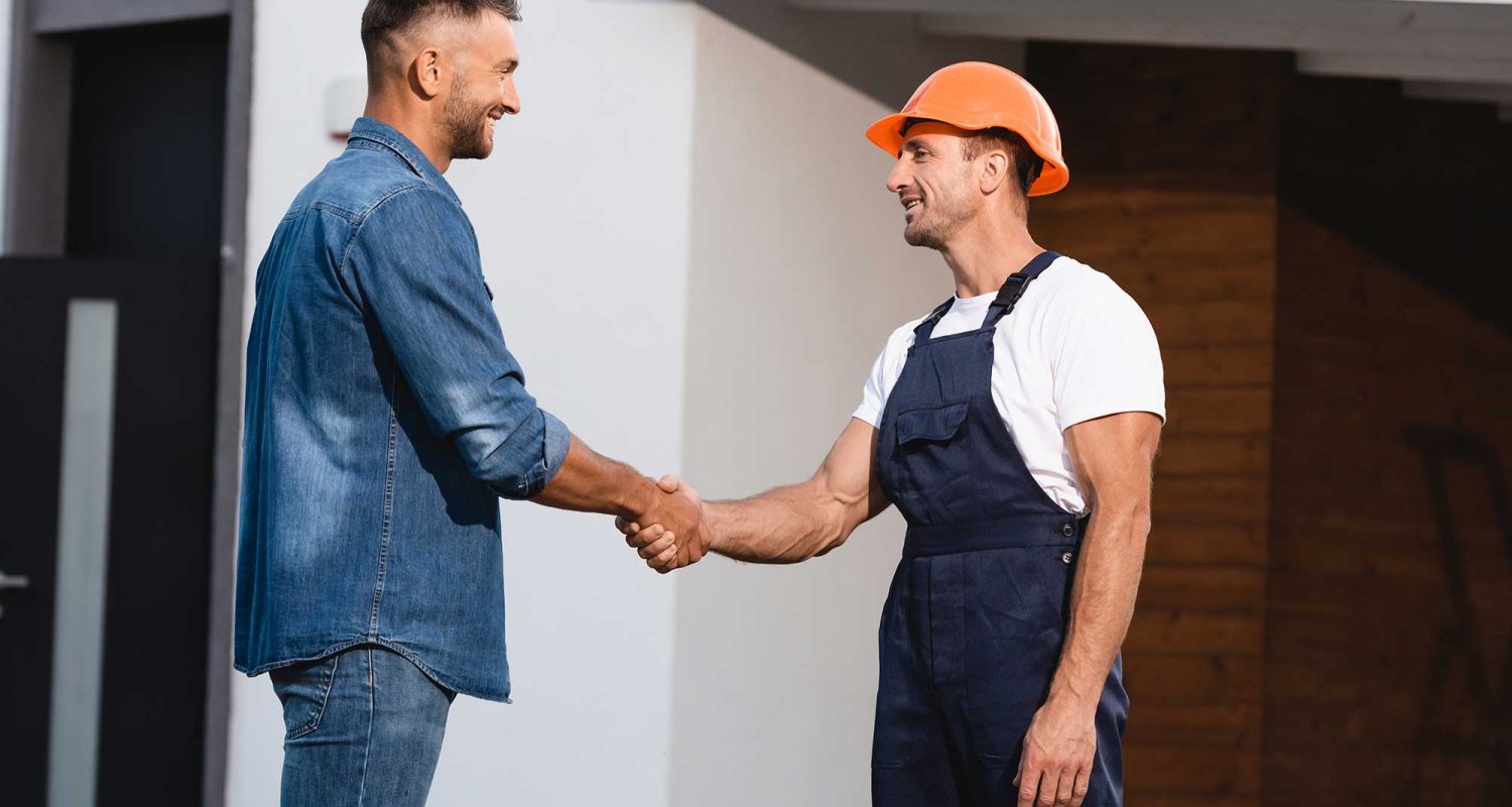 man-shaking-hands-with-builder-in-uniform-near-bui-2022-11-11-00-59-49-utc.jpg