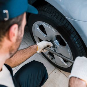 selective-focus-of-car-mechanic-changing-car-tire-2022-12-16-19-59-09-utc