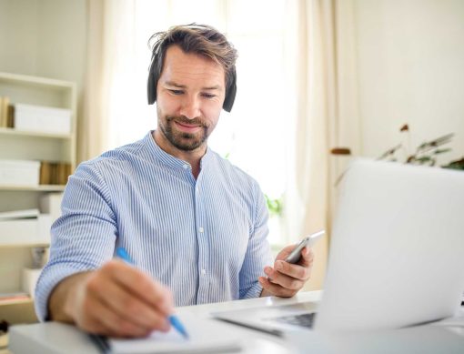 mature-businessman-with-headphones-and-laptop-indo-2022-02-02-03-59-12-utc