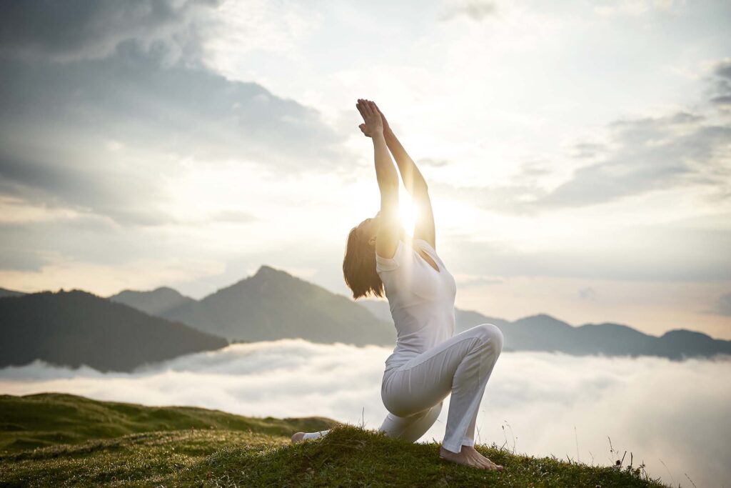 austria-kranzhorn-mid-adult-woman-practising-yoga-MTJ5JCR.jpg